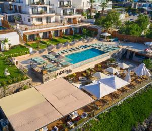 an aerial view of a resort with a swimming pool at niXie Hotel & Beach - Adult Only in Yalıkavak