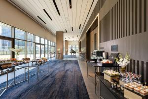 a large lobby with tables of food on display at DoubleTree By Hilton Seoul Pangyo in Seongnam