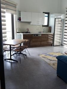 a kitchen with a table and chairs and a refrigerator at Datça Zeytinevleri Apart in Datca +12 photos