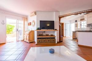 a large living room with a tv and a kitchen at Apartment Chateau Morro 4 in Morro del Jable +30 photos