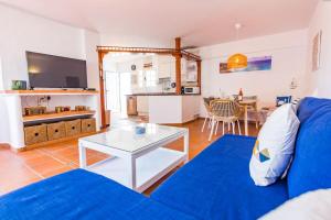 a living room with a blue couch and a table at Apartment Chateau Morro 4 in Morro del Jable