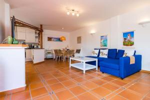 a living room with a blue couch and a table at Apartment Chateau Morro 4 in Morro del Jable