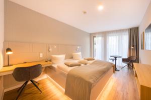 a hotel room with a bed and a desk at Design Apartments Potsdam - Luise in Potsdam