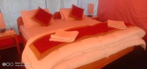 a bedroom with a large bed with pillows at Saser Camp in Nubra