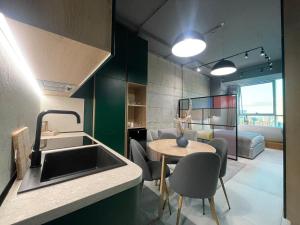 a kitchen and living room with a sink and a table at Ambassador Skyline Apartments in Tirana