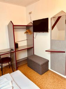 Zimmer mit einem Schlafzimmer mit einem Bett und einem TV in der Unterkunft Gästehaus Spoth in Rust