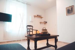 a room with a wooden table and a chair at Le Racine, Charmant T3 en centre ville in Tours