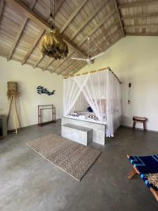 a bedroom with a bed with a mosquito net at Simply Peace in Tangalle