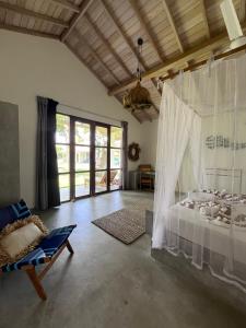 a bedroom with a bed with a white canopy at Simply Peace in Tangalle