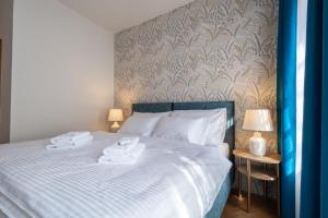 Posteľ alebo postele v izbe v ubytovaní Hotel Tanzberg Mikulov