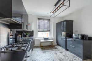 a kitchen with black and white tile flooring at Peacefully set 2level 2BR btw Brixton & Camberwell in London