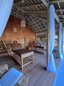 a covered porch with two benches and a table at Simply Peace in Tangalle