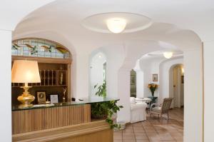 a living room with a counter and a dining room at Hotel Villa Angelica in Ischia