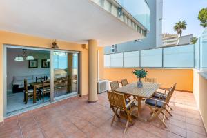 a patio with a table and chairs on a balcony at Holiday rental Apartment Puerto Marina with Free Parking. in Benalmádena