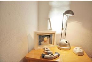 a desk with a lamp and a picture on it at Nice View Apartment in Ivanica +3 photos