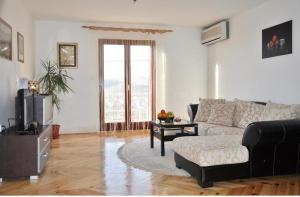 a living room with a couch and a table at Nice View Apartment in Ivanica