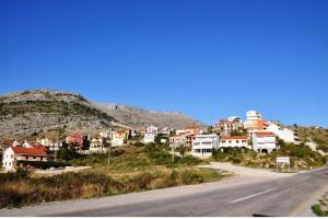 a town on the side of a mountain with a road at Nice View Apartment in Ivanica