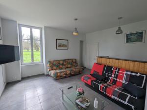 a living room with a couch and a tv at Maison de maître au cœur du Berry avec étang privé, grand jardin et vaste propriété - FR-1-591-116 in Migné
