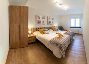 1 dormitorio con 1 cama grande y armario de madera en Apartamento Larrazu Agroturismo Baztán, en Arráyoz