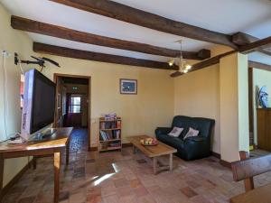 a living room with a couch and a table at Domaine paisible au cœur du Berry, proche Parc de la Brenne, 6 chambres, cheminée, idéal familles - FR-1-591-200 in Mauvières