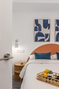 a bedroom with a bed with a tray of fruit on it at BNBHolder Inspiring Salamanca in Madrid