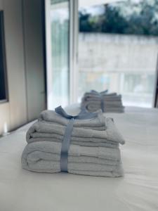 a stack of towels with a blue ribbon sitting on a floor at Casa Adele in Salerno