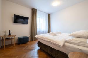 Posteľ alebo postele v izbe v ubytovaní Hotel Tanzberg Mikulov
