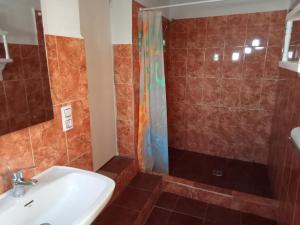a bathroom with a sink and a shower at El Almendro De La Tia Teresa in Prados de Armijo +24 photos