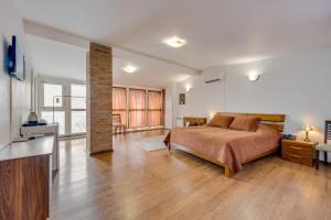 a bedroom with a bed and a living room at Boutique Hotel in Tbilisi City