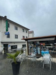 a group of chairs and tables in front of a building at P Residencia PIVIDAL in Picaraña