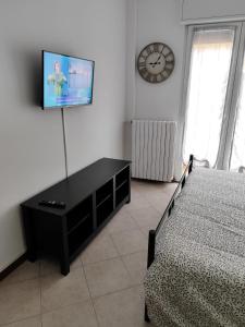 a bedroom with a bed and a tv on a wall at Zinexium in Gignese