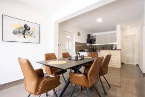 a kitchen and dining room with a table and chairs at Villa Stone - Pool house 100 meters from the beach in Vinišće +27 photos