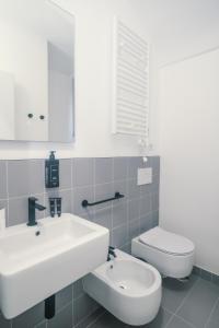 a bathroom with a white sink and a toilet at Youroom Monteverde - Rooms in Rome