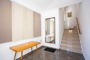 a hallway with a wooden table and stairs at Villa Stone - Pool house 100 meters from the beach in Vinišće