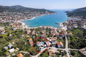 an aerial view of a village with a red circle at Villa Stone - Pool house 100 meters from the beach in Vinišće