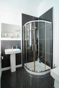 a bathroom with a shower and a sink at Plymouth Hoe - Beautiful 5 Bedroom Victorian House - Central Location in Plymouth
