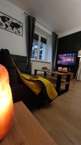 a living room with a couch and a table at Underground Cave Apartment in Wieliczka