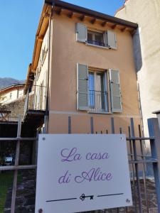a building with a sign in front of it at LA CASA DI ALICE in Lenno