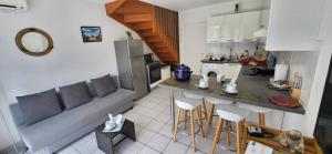 a kitchen with a couch and a table and chairs at Mazet 5 pers plage parking gratuit wifi clim in La Londe-les-Maures