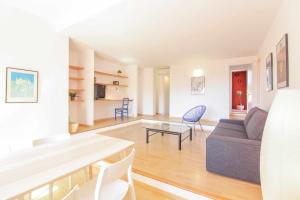 a living room with a couch and a table at Apartment in Muralla Roja - 0413 in Calpe +11 photos