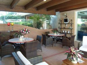 an outdoor patio with two tables and chairs at Residence Torre Del Mar in Alba Adriatica