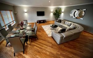 a living room with a couch and a table at The Cottage @ The Vu in Torphichen