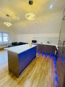 a kitchen with a blue island in a living room at VIP penthouse own bathroom one bedroom on suite in Wolverhampton