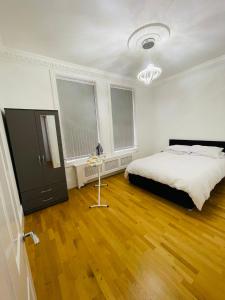 a bedroom with a bed and a wooden floor at VIP penthouse own bathroom one bedroom on suite in Wolverhampton