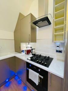 a kitchen with a black stove top oven at VIP penthouse own bathroom one bedroom on suite in Wolverhampton
