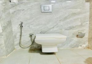a bathroom with a white toilet and a shower at Hotel Seven Inn (R S Gorup Near Delhi Airport) in New Delhi