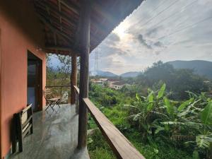 a balcony of a house with a view of the mountains at Casa da JUJU - Praia da Lagoinha - Ubatuba in Ubatuba