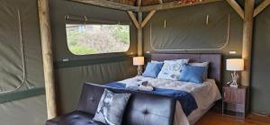 a bedroom with a bed and a window at Harmony Luxury Tents & Safari in Addo