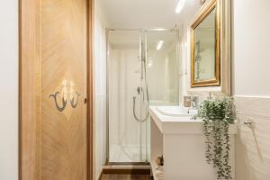 a bathroom with a shower and a sink and a mirror at Guest House Maison 6 in Lido di Ostia +25 photos