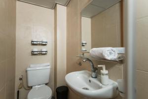 a bathroom with a sink and a toilet and a mirror at 2BD and 2 Bath duplex on the Hilton beach with a shelter in Tel Aviv +13 photos